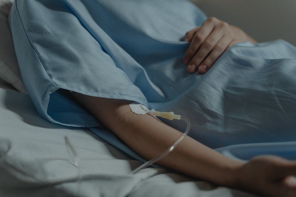 Woman recovering from surgery  receiving IV therapy after surgery