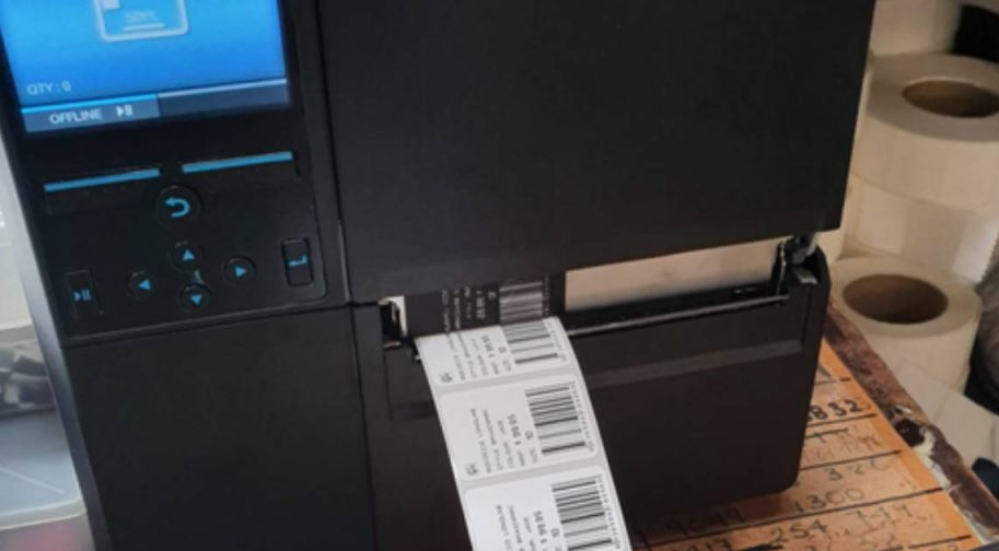 a label printer is sitting on a table printing fresh labels
