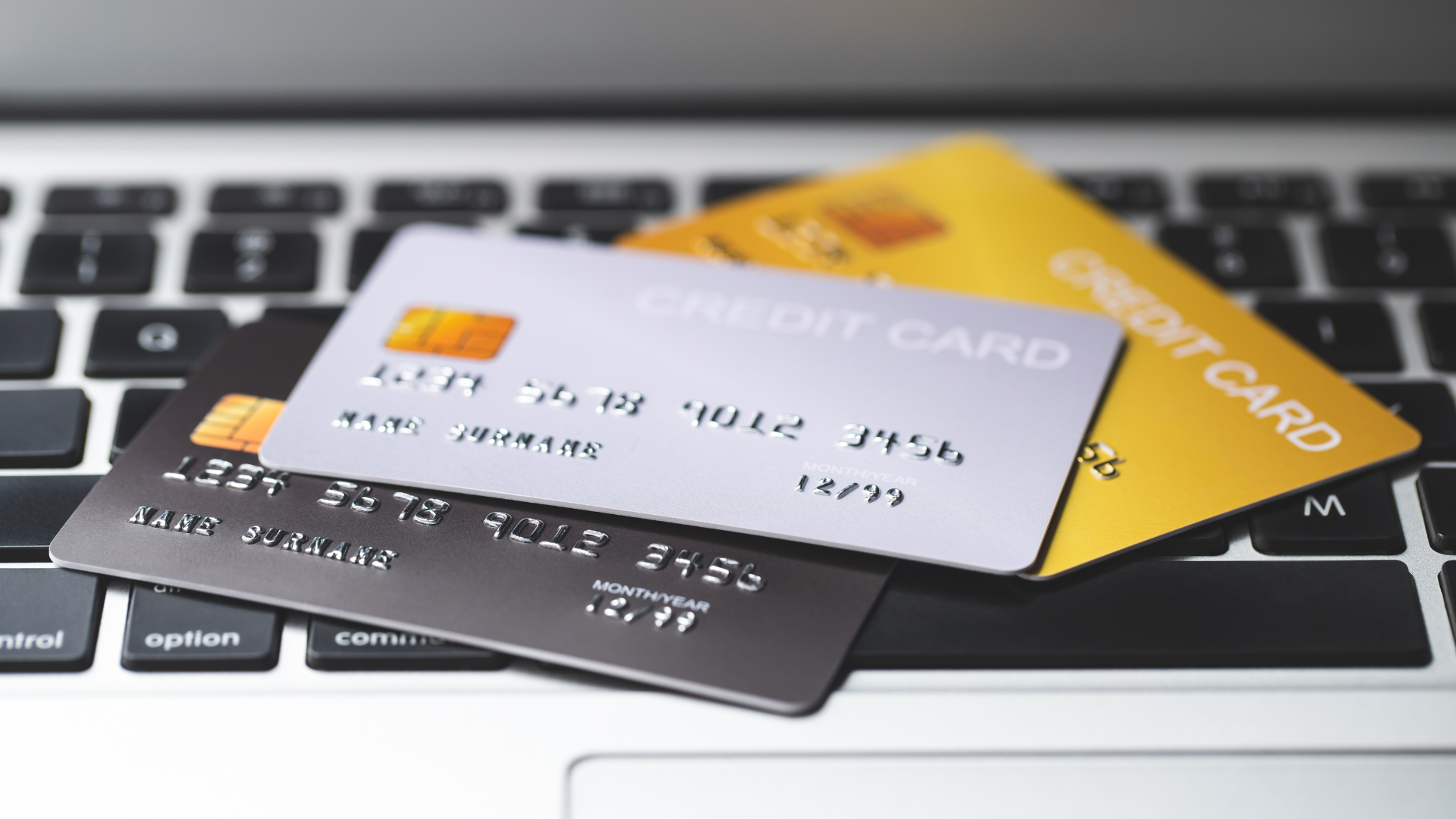 Stack of credit cards on a laptop keyboard
