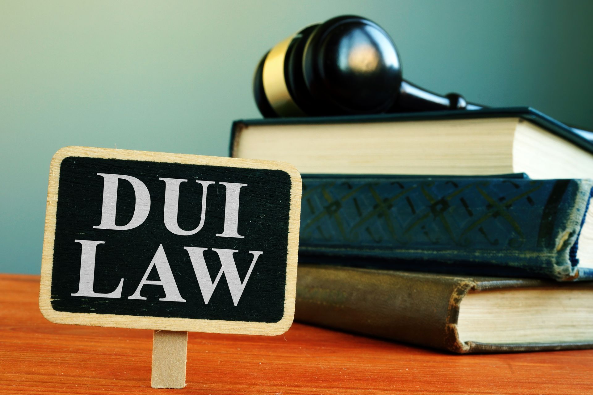  DUI law books and judge gavel on desk representing court process and ADSAC evaluation requirements