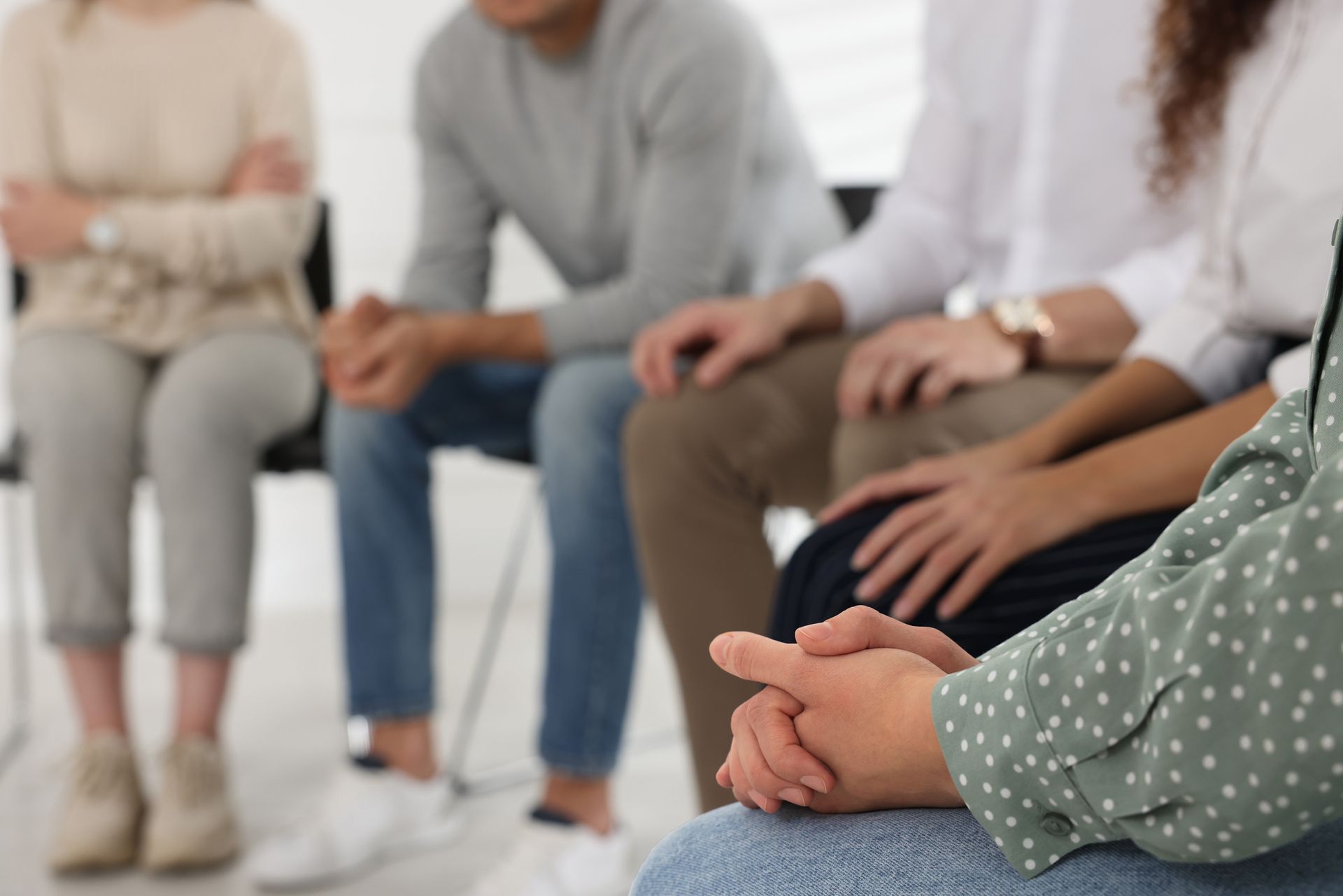 People at group therapy session indoors.