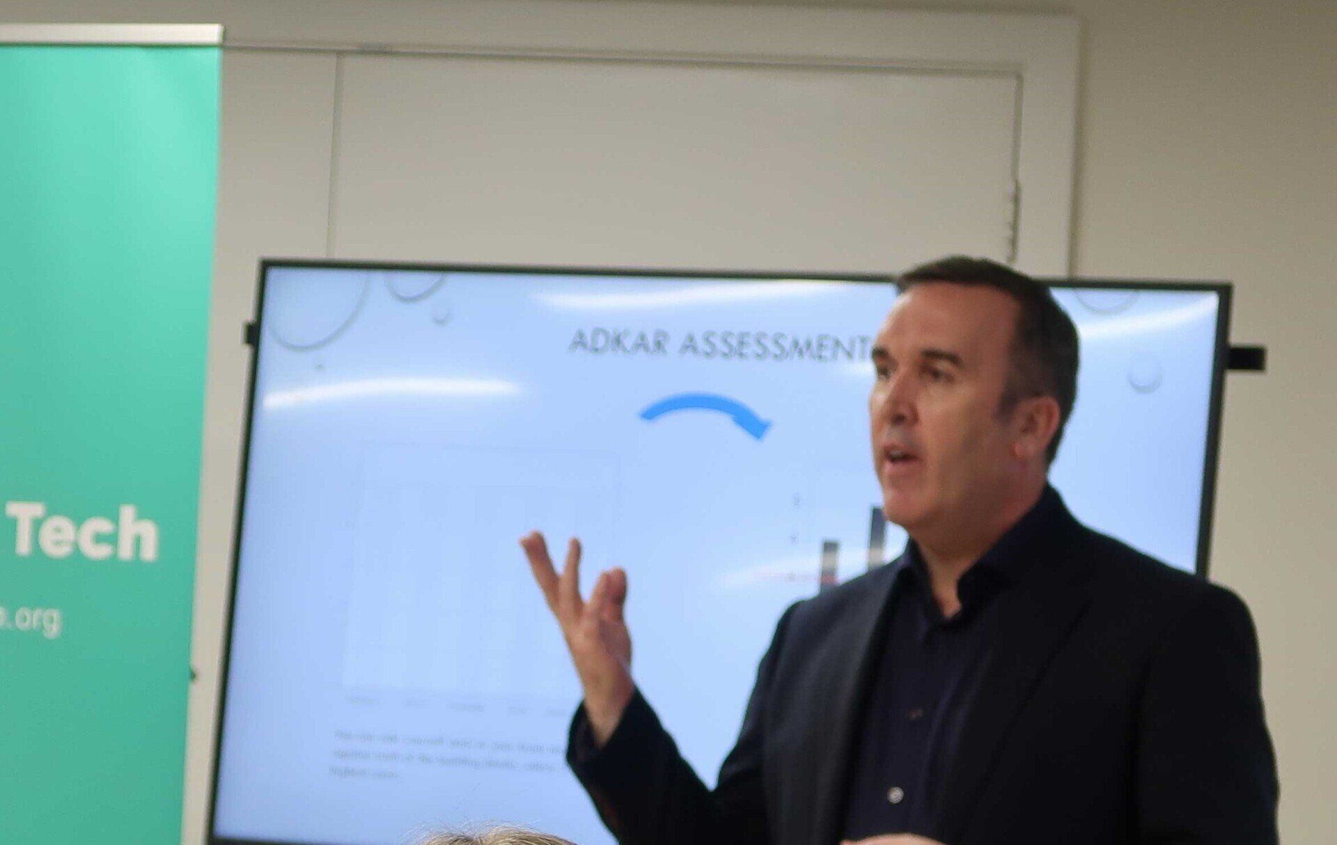 Man giving a presentation. Screen displays
