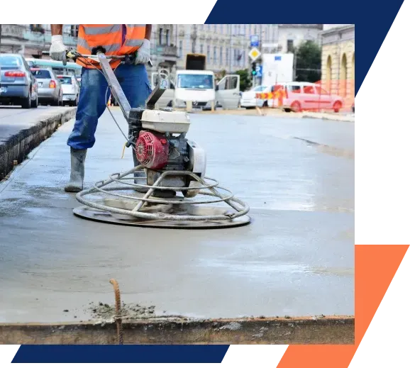 A man is using a machine to level a concrete surface.