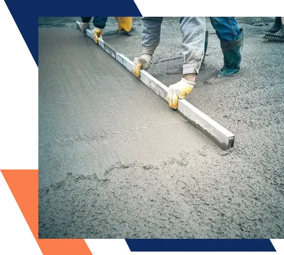 A person is leveling concrete with a ruler