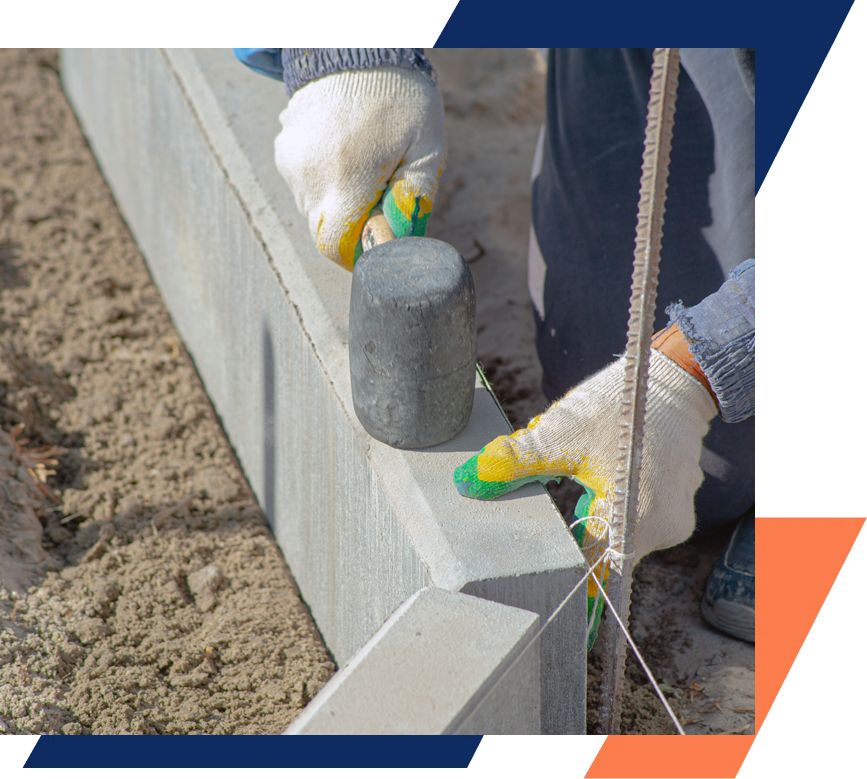 A person is using a measuring tape to measure a concrete wall.