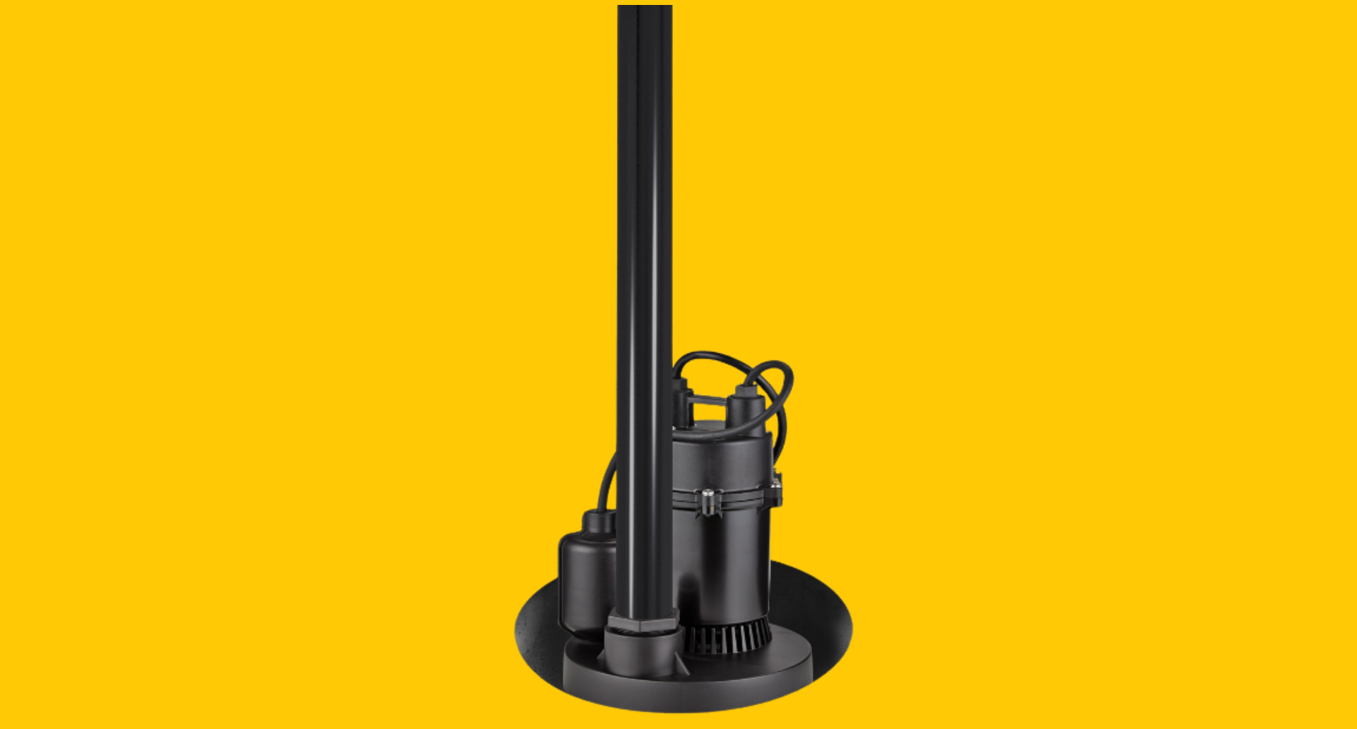 Black sump pump installed in a circular basin, against a yellow background. The pump has a vertical pipe extending upwards.