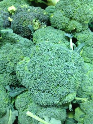A bunch of broccoli heads are sitting on top of each other.