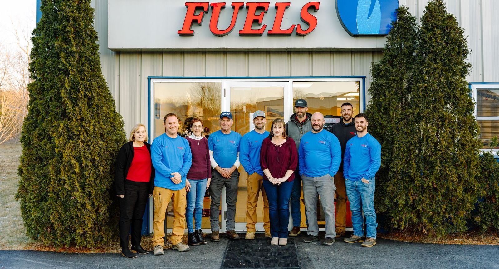 A group of people are posing for a picture in front of a building.