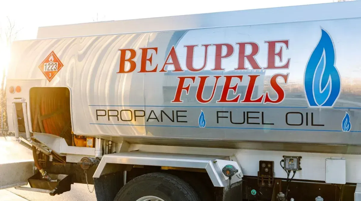 A beaupre fuels propane and fuel oil truck is parked in the snow.