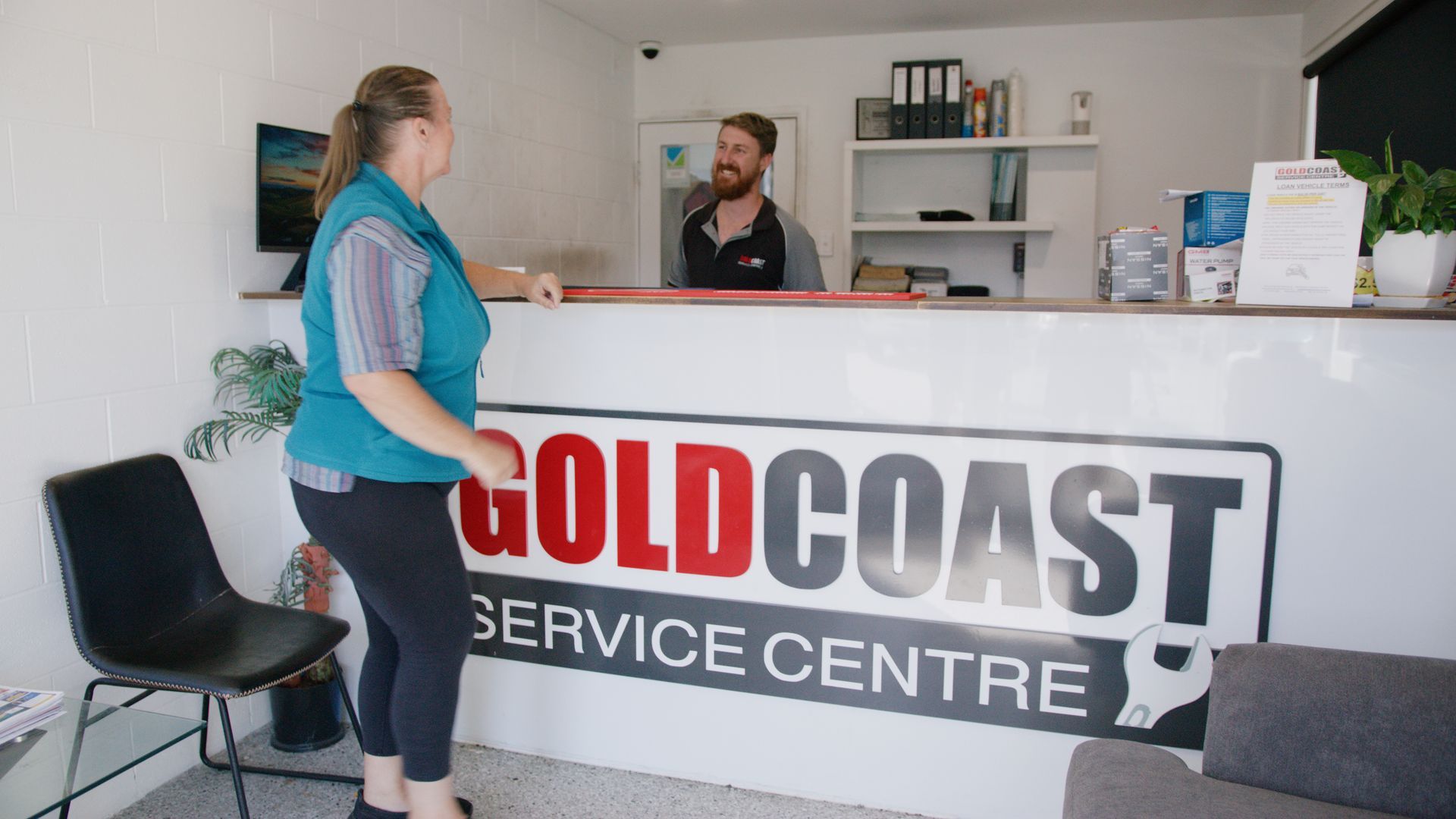 Reception desk at Gold Coast Service Centre with a customer speaking to staff.