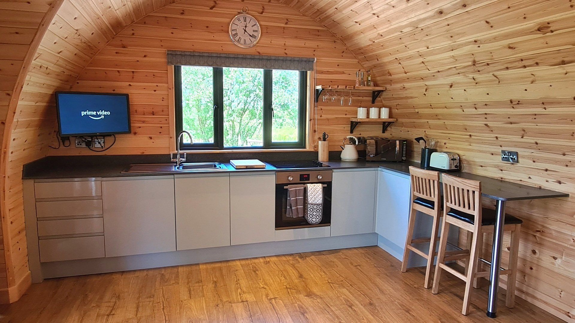 A kitchen in a log cabin with a table and chairs.