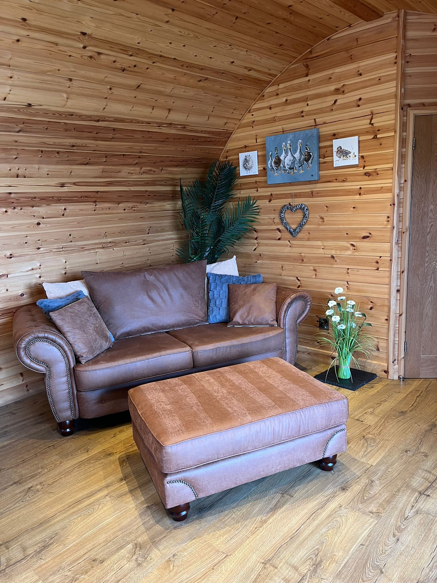 There is a couch and ottoman in the living room.
