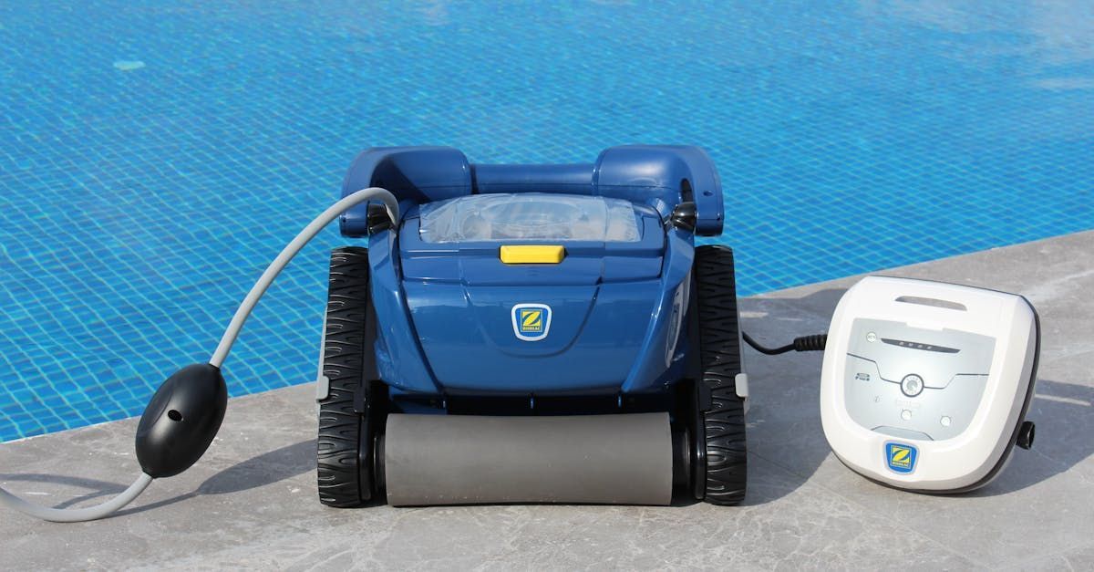 A robotic vacuum cleaner is sitting next to a swimming pool.