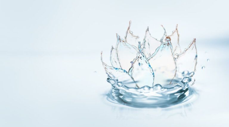 Water splash forming a crown on a white background