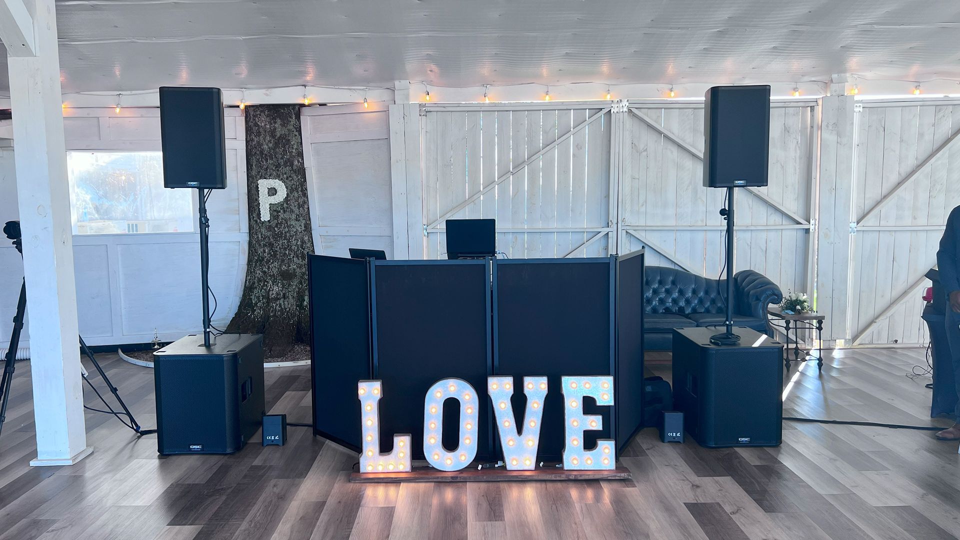 DJ setup with speakers, mixer, and glowing 