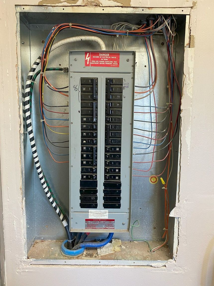 Three blue electrical outlets mounted side by side on a white wall.
