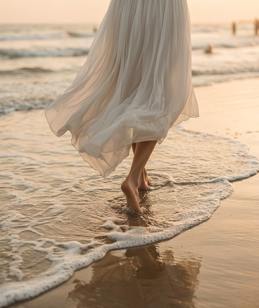 穿著白裙於夕陽海灘漫步的畫面，傳遞自在從容的現代女性生活態度 - Loventrx 艾凡翠思
