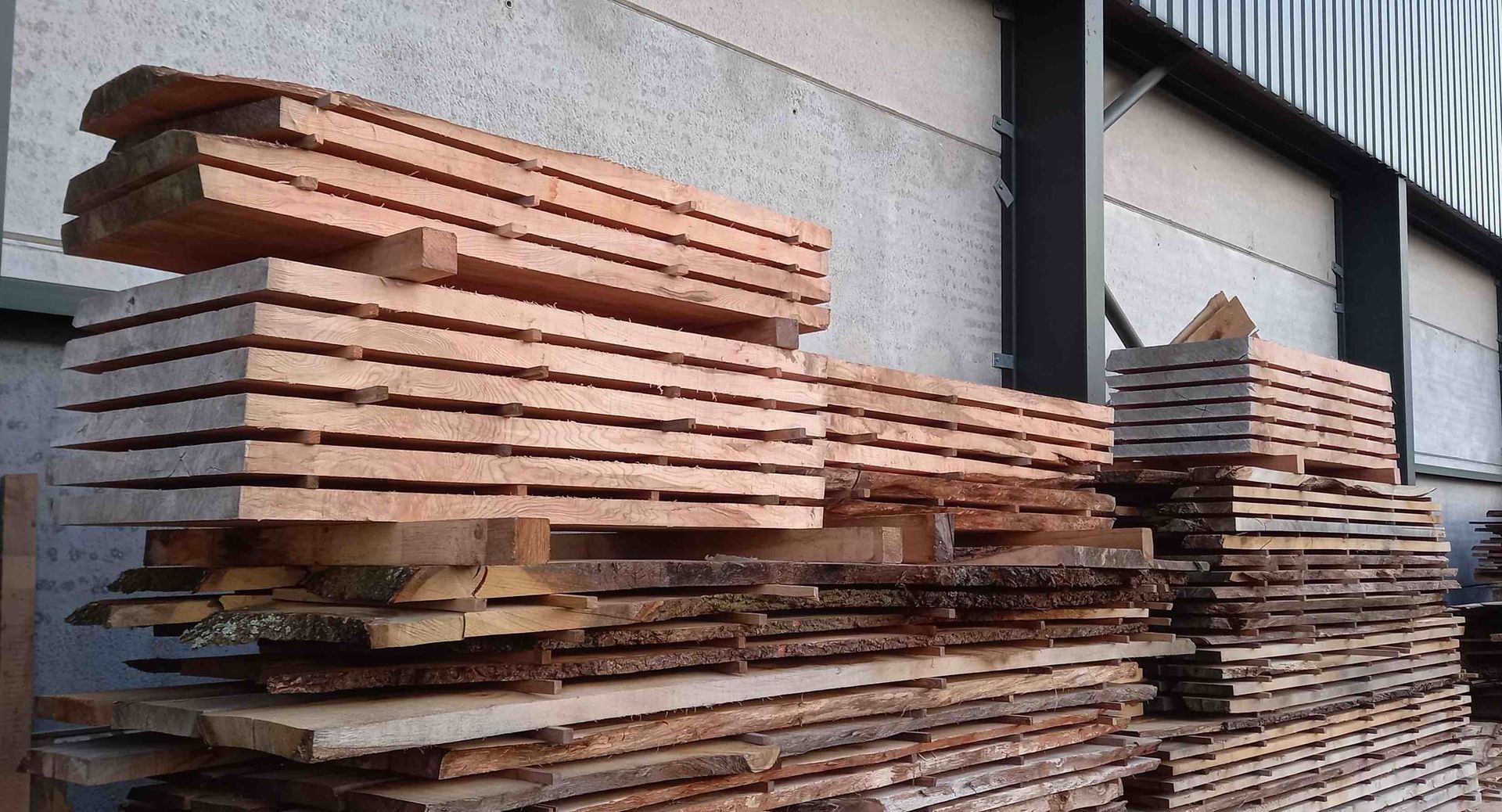 Timber stacks drying in outside in the sunlight. Also classed as air-drying