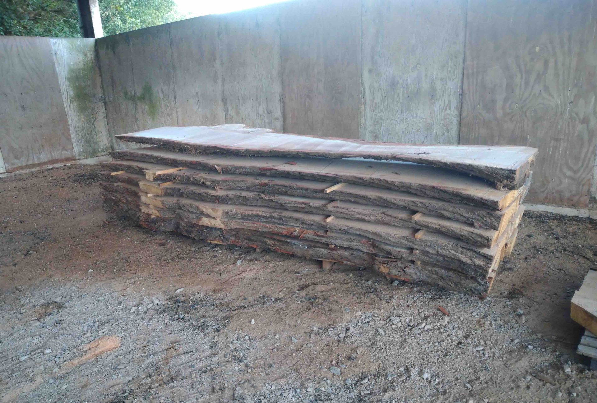 Milled planks neatly stacked and sticked out to dry.