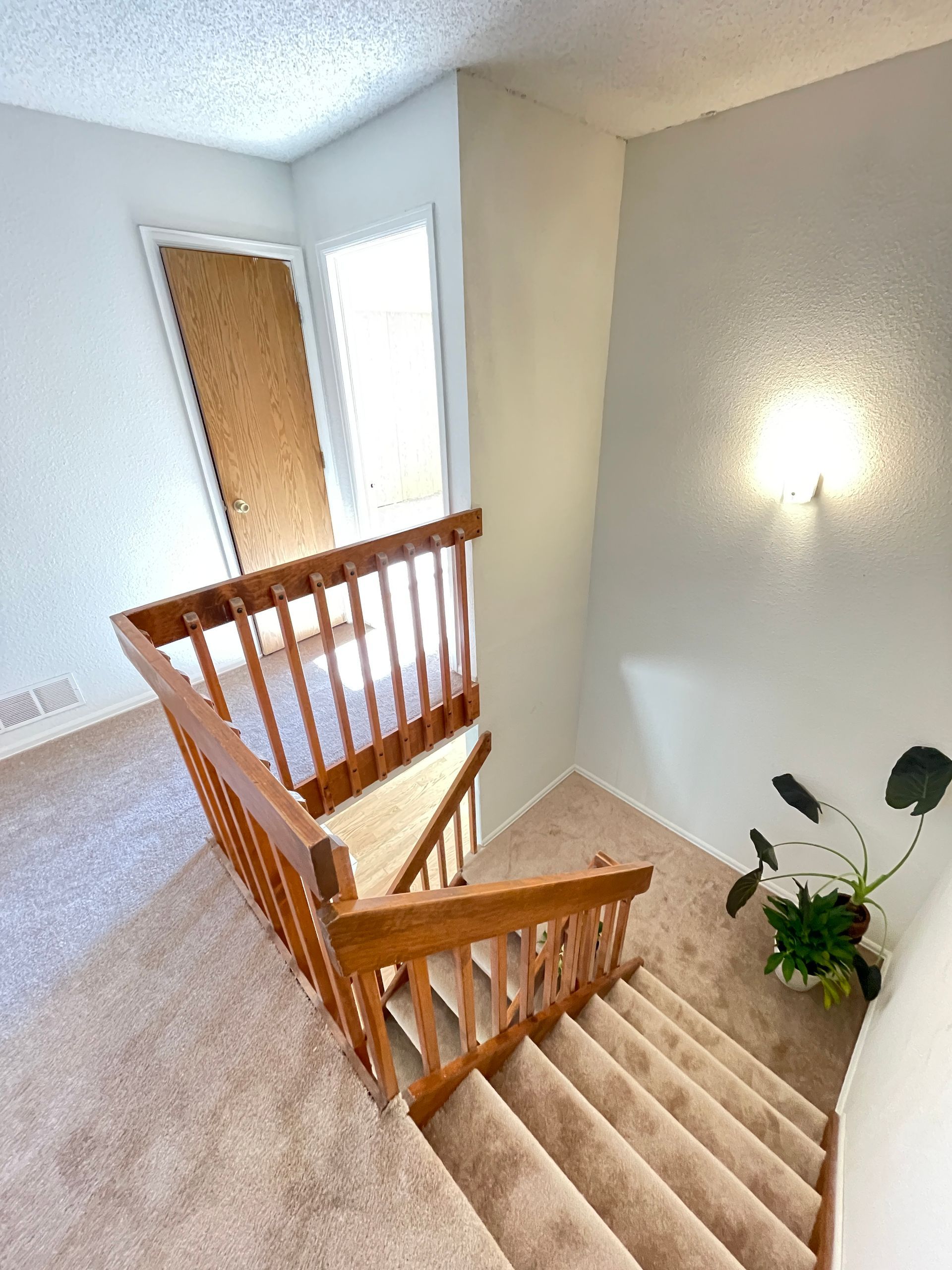 A staircase with a wooden railing in a house