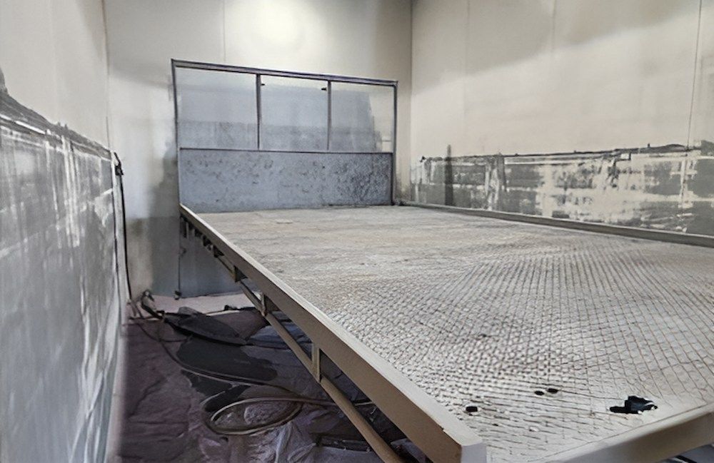 A Large Metal Platform Is Sitting In A Room Next To A Wall — ADK Coatings In Toolooa, QLD