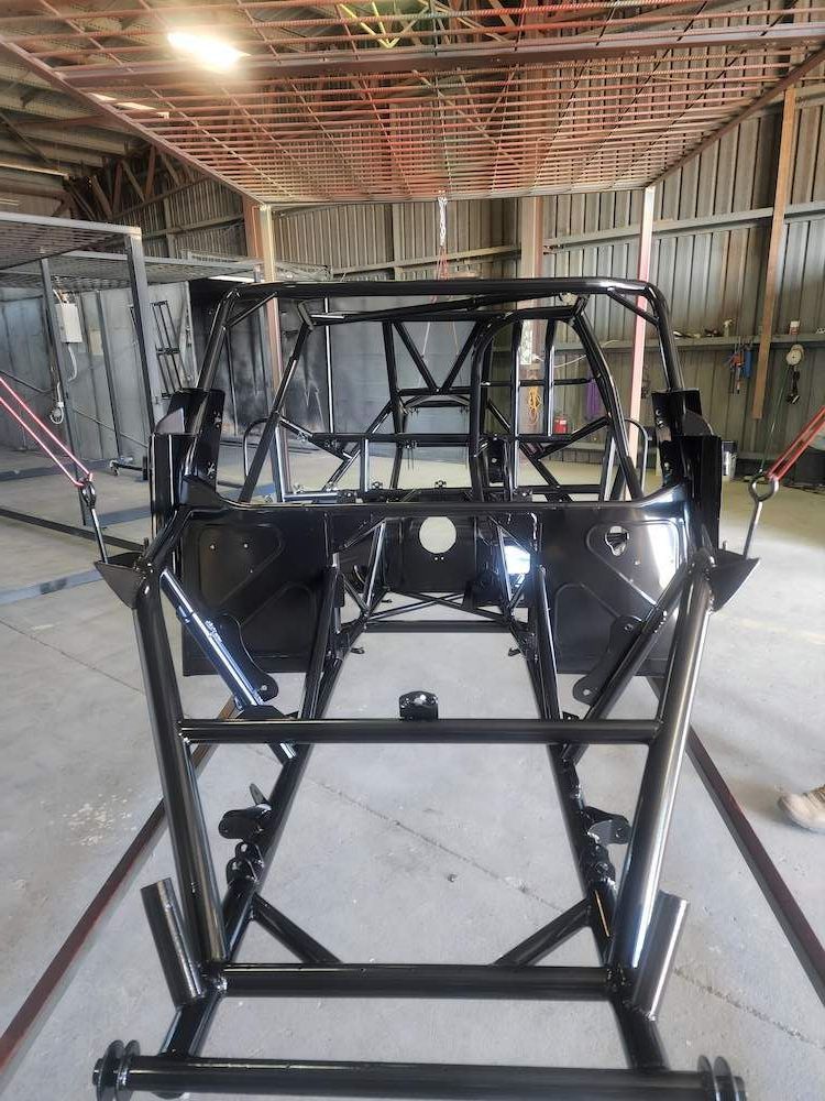 A Car Frame Is Sitting Inside Of A Building — ADK Coatings In Gladstone, QLD
