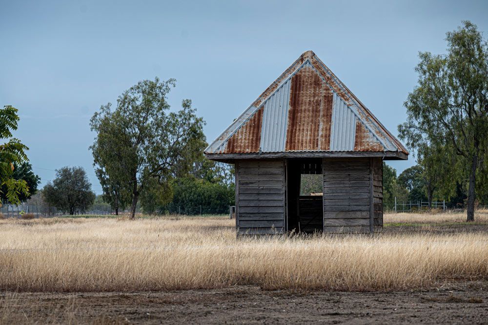 An Old Wooden House With A Rusty Tin Roof — ADK Coatings In Biloela, QLD