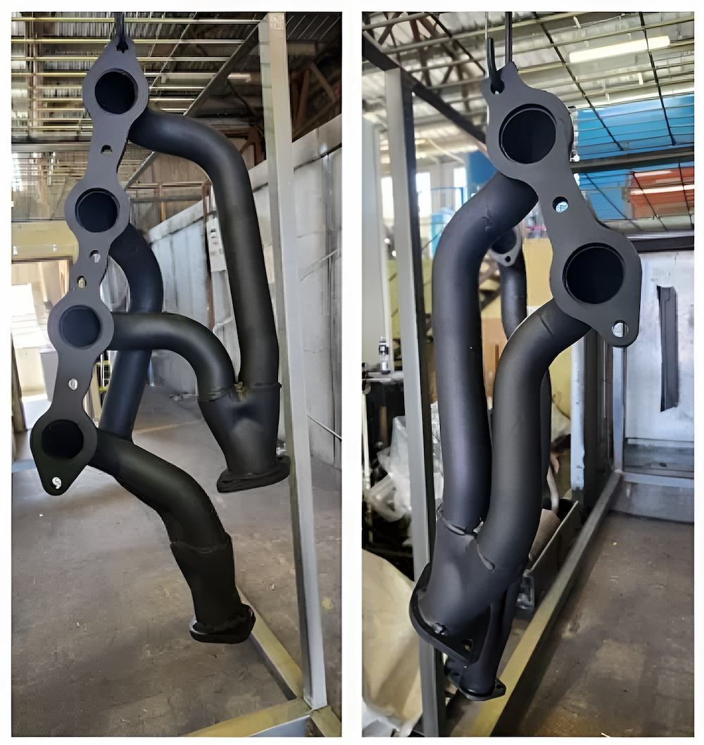 A Pair Of Black Pipes Sitting On Top Of Each Other In A Warehouse — ADK Coatings In Gladstone, QLD