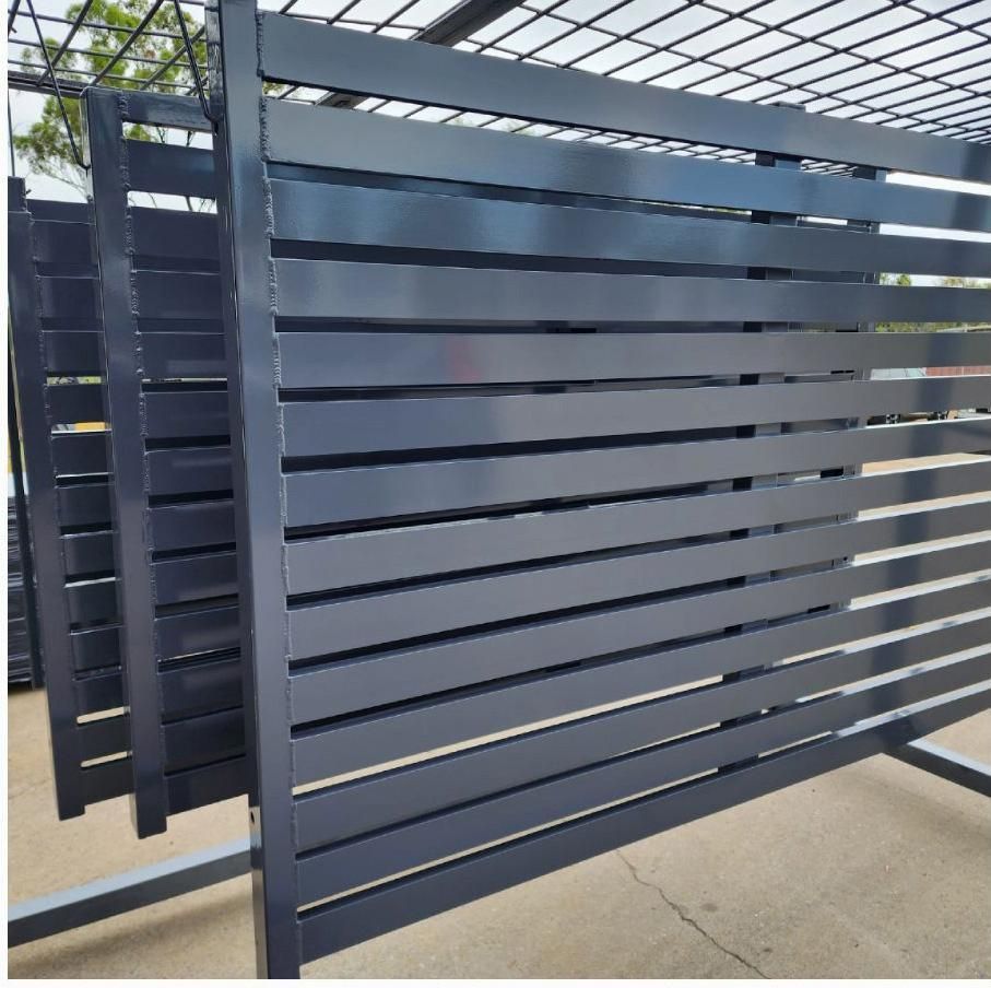 A Black Metal Fence Is Sitting On The Ground — ADK Coatings In Toolooa, QLD