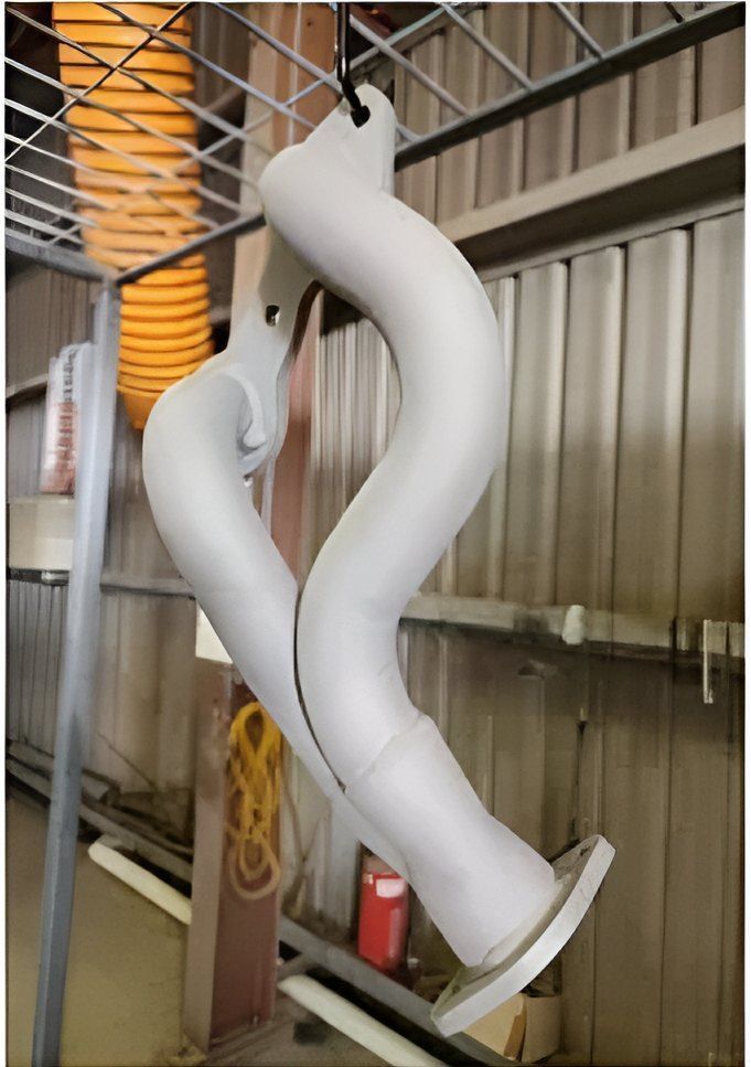 A White Pipe Is Hanging From A Metal Rack In A Room — ADK Coatings In Toolooa, QLD
