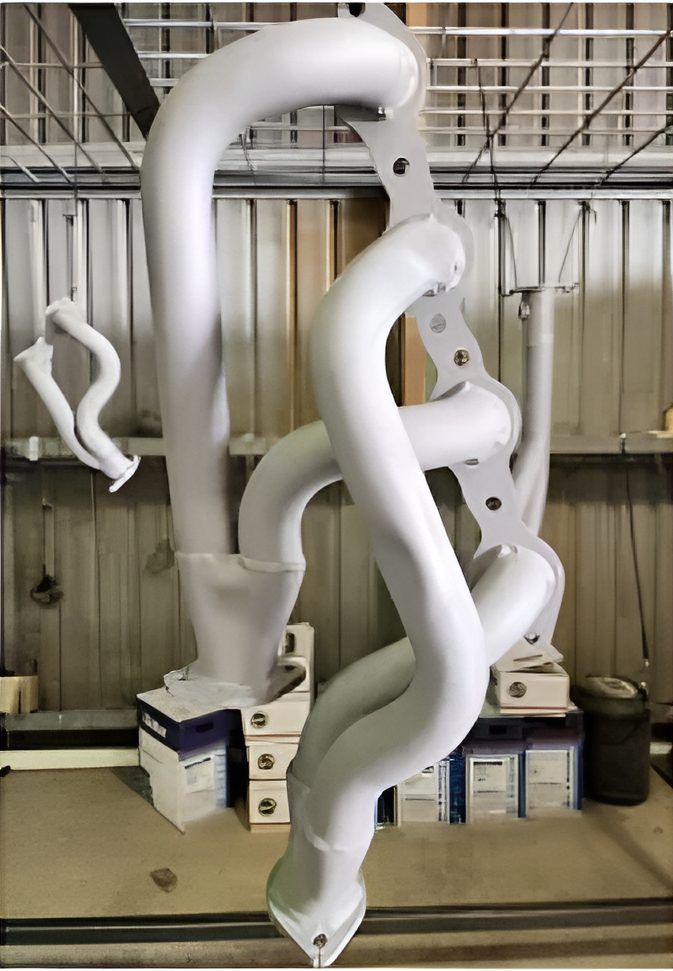 A Bunch Of White Pipes Are Hanging From The Ceiling In A Garage — ADK Coatings In Toolooa, QLD