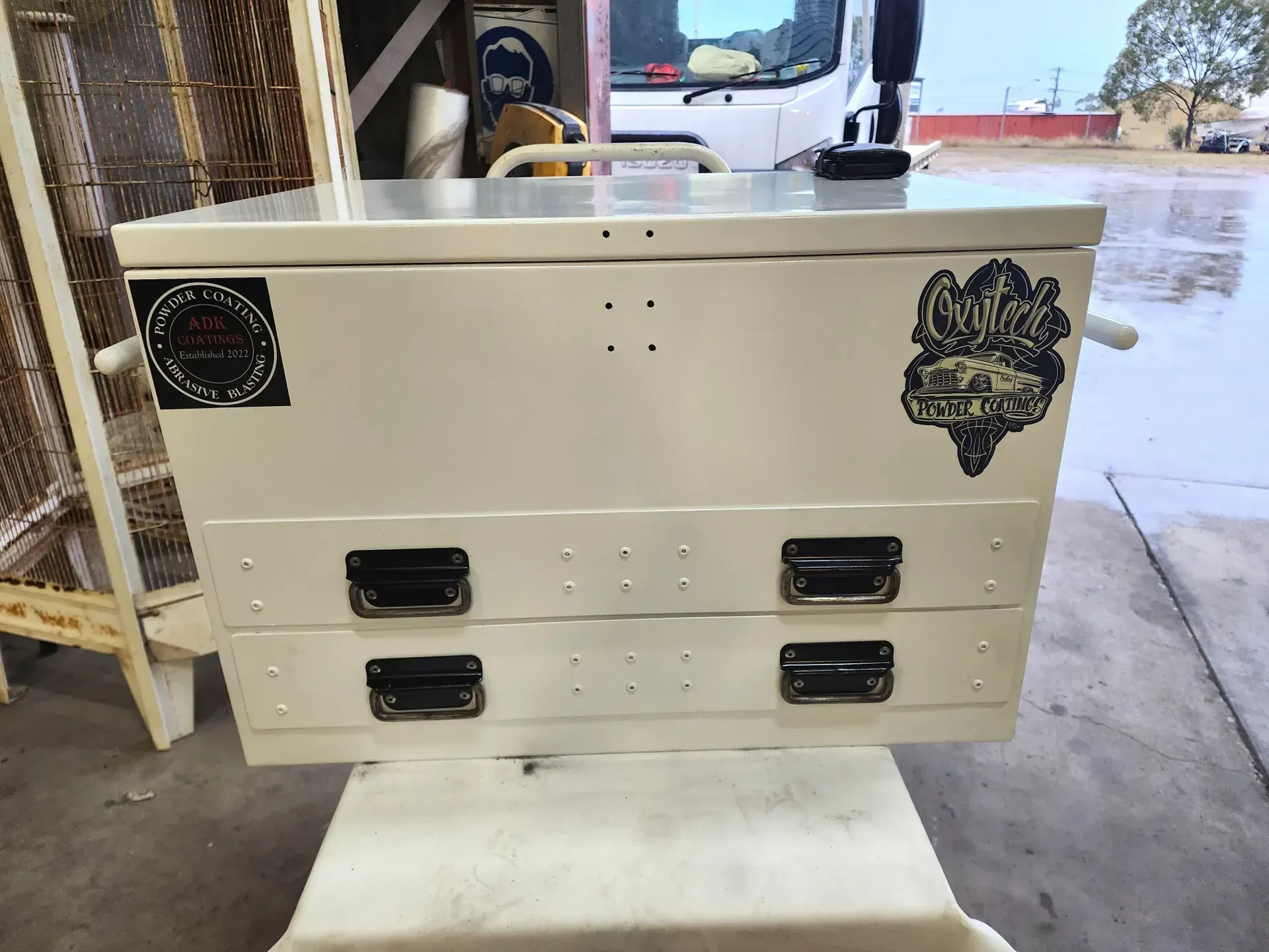 A White Toolbox With Three Drawers Is Sitting On Top Of A White Table — ADK Coatings In Tannum Sands, QLD