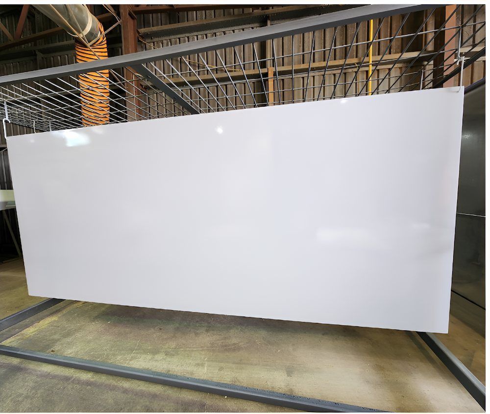 A Large White Board Is Hanging From A Metal Rack In A Warehouse — ADK Coatings In Toolooa, QLD
