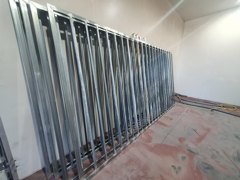 A Room With A Lot Of Metal Frames On The Wall — ADK Coatings In Boyne Island, QLD