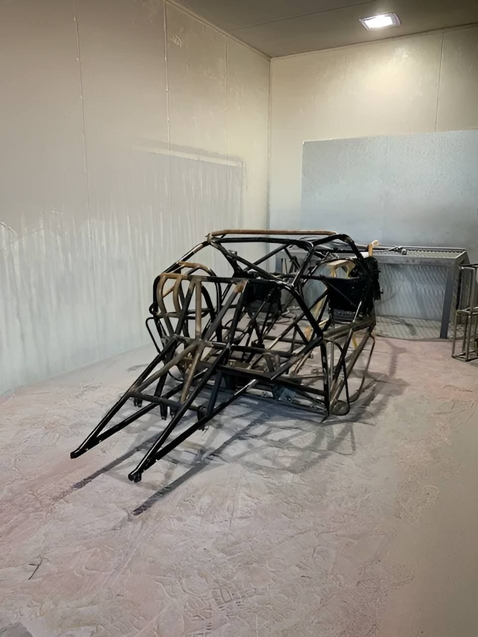 A Metal Frame Of A Car Is Sitting In A Room — ADK Coatings In Toolooa, QLD