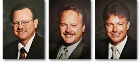 Three formal headshots of men in suits and ties, arranged side by side.