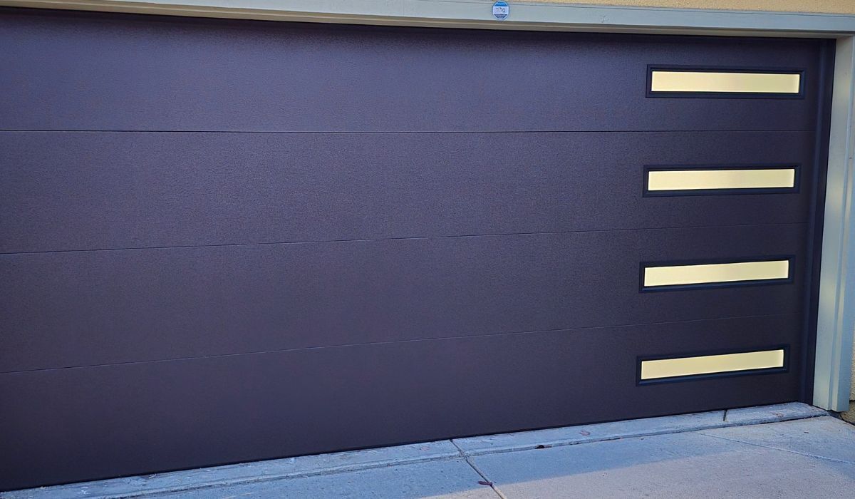 Dark purple garage door with three cream horizontal panels on the right side