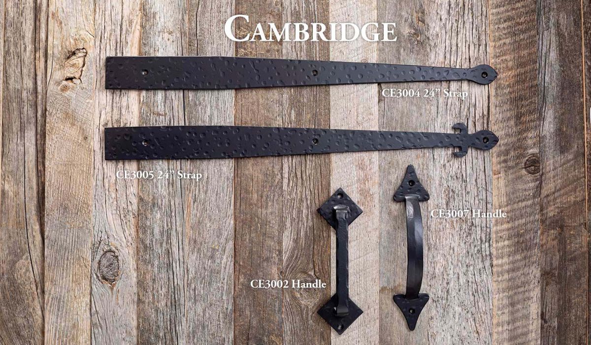 Cambridge-branded black leather straps and metal clasps on a wooden surface with size text.