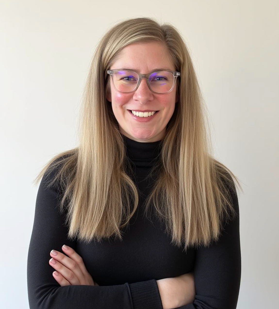 A woman in a purple sweater is smiling for the camera.