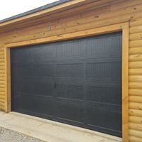 Dark garage door on a wood-sided building