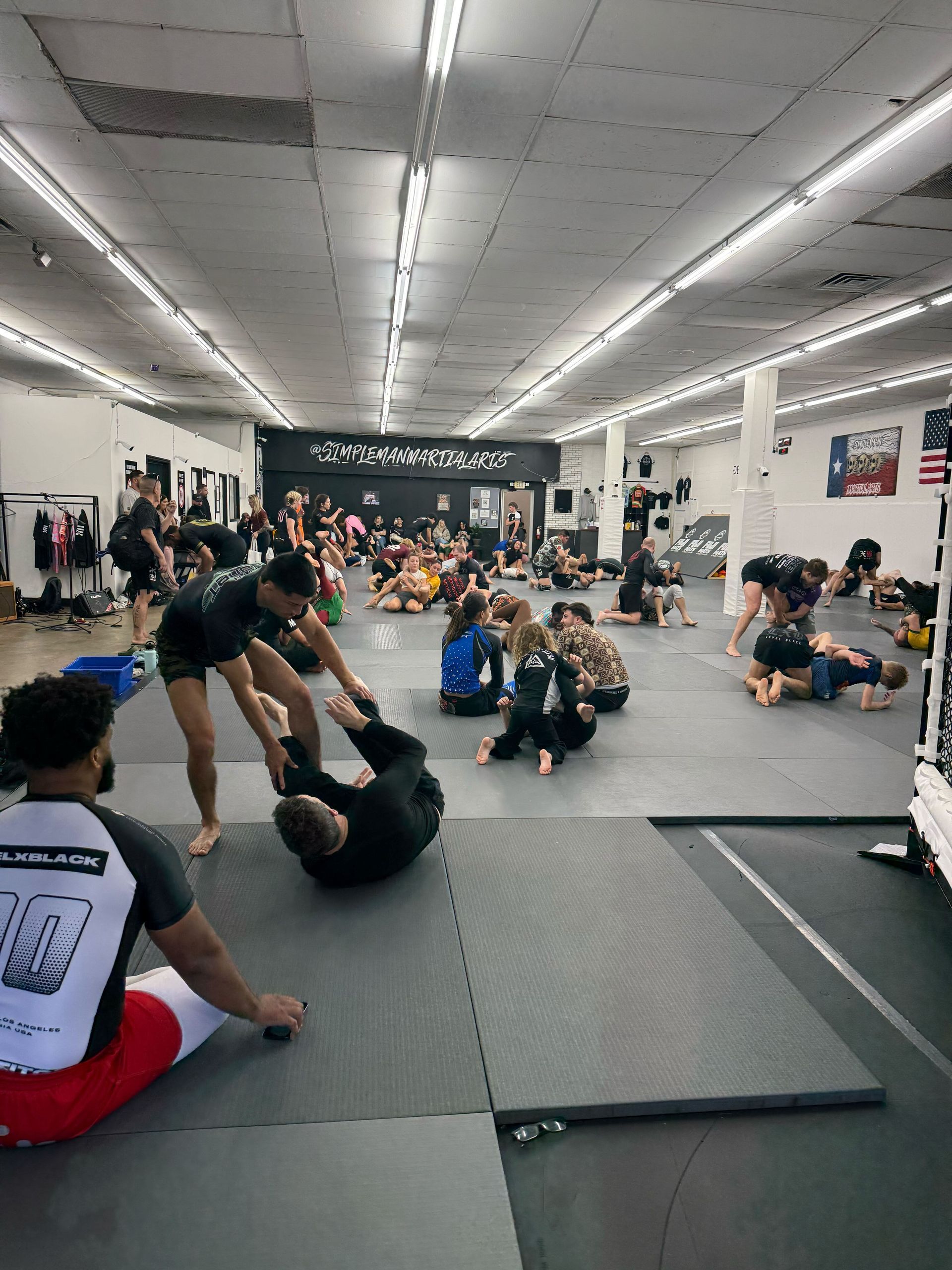 Adults training Brazilian Jiu-Jitsu at Simple Man Martial Arts in Austin, Texas, building fitness.