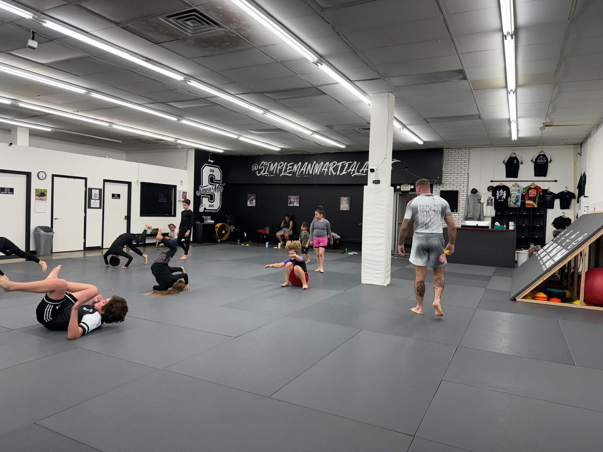 Students practice no-gi grappling at Simple Man Martial Arts in Austin, TX, building calm, real-world confidence.