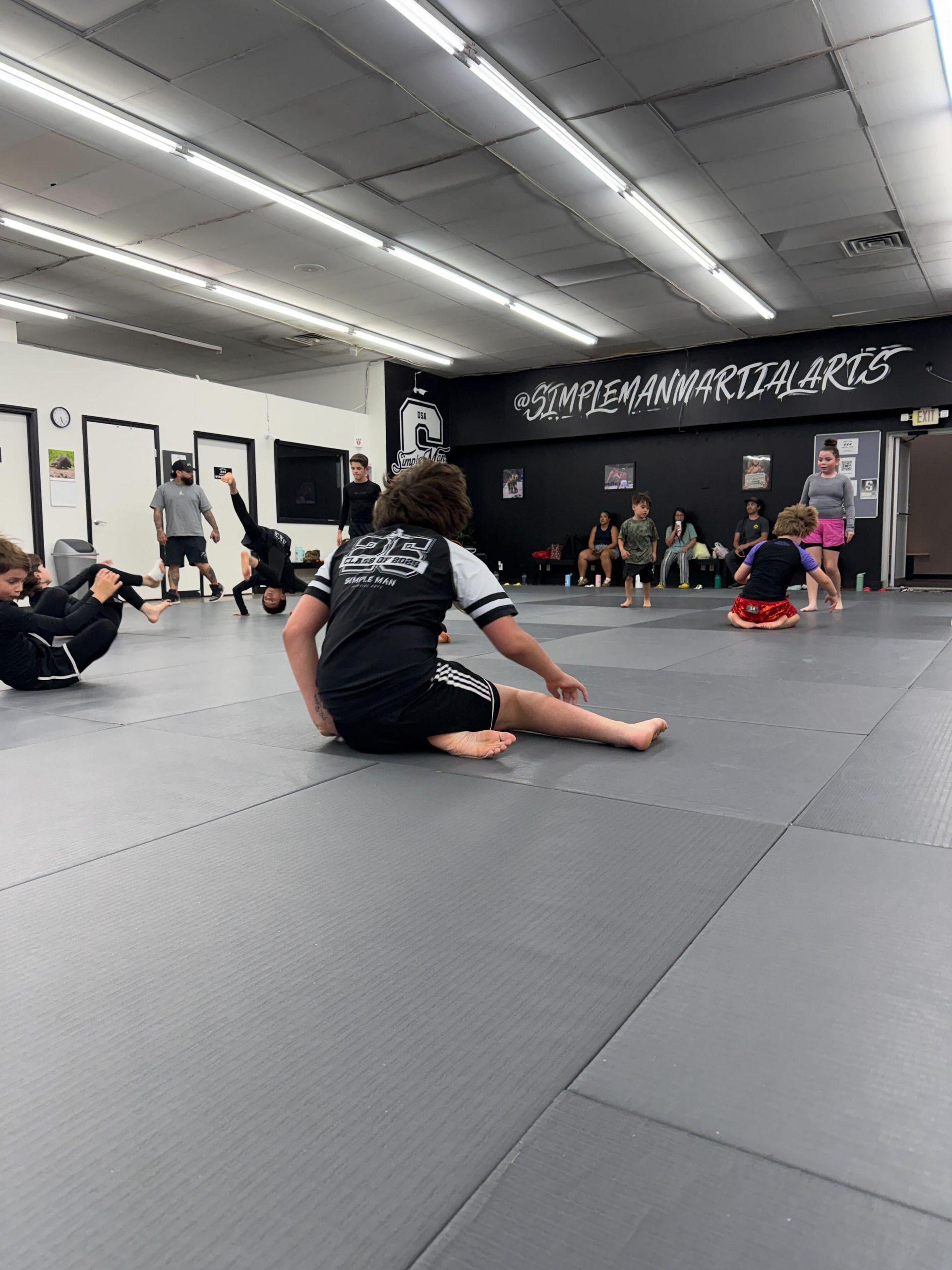 Students drilling Jiu-Jitsu control and escapes at Simple Man Martial Arts in Austin, TX for practical confidence