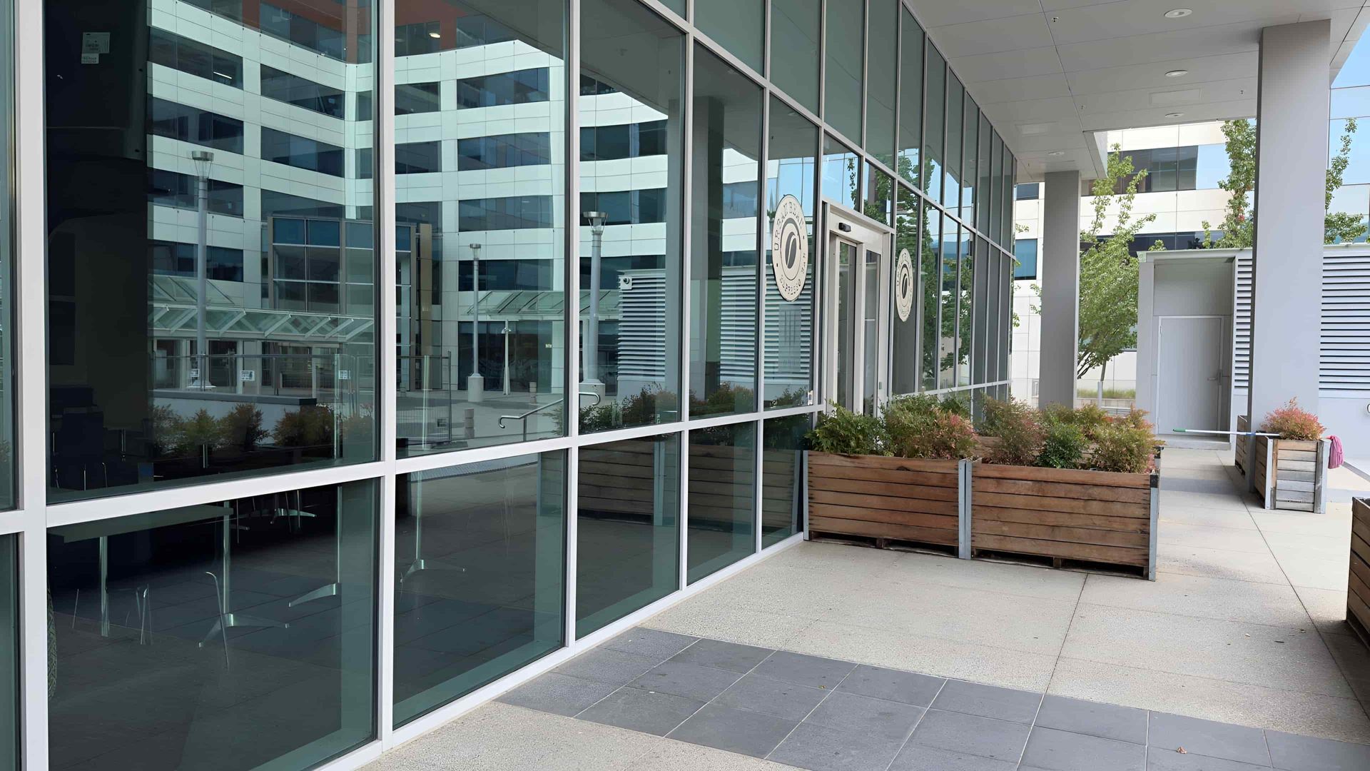 Exterior of a Modern Building With Large Windows Reflecting — Cleanaroo Property Services in Conder, ACT