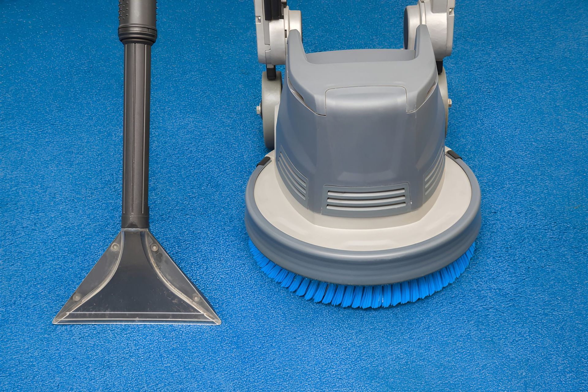 Carpet Cleaner With Brush Head and Vacuum Nozzle on Blue Carpet — Cleanaroo Property Services in Conder, ACT