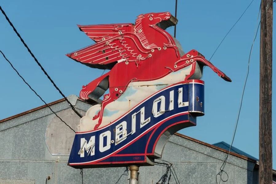 A weathered Mobil Oil Pegasus sign with red wings, over