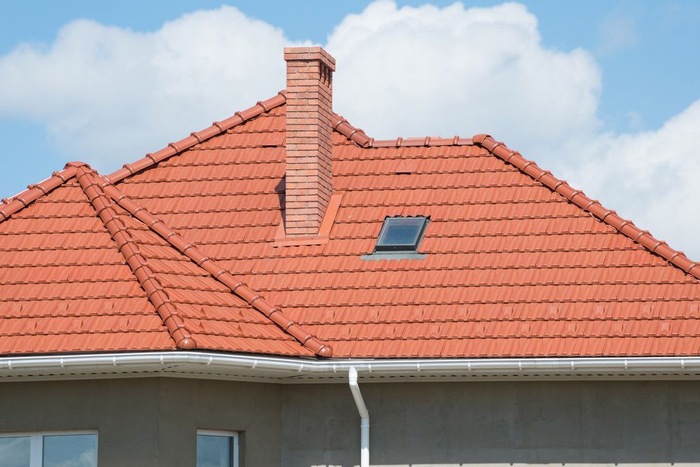 The Roof Of A House With A Chimney — Topflite Roofing In Vincentia, NSW