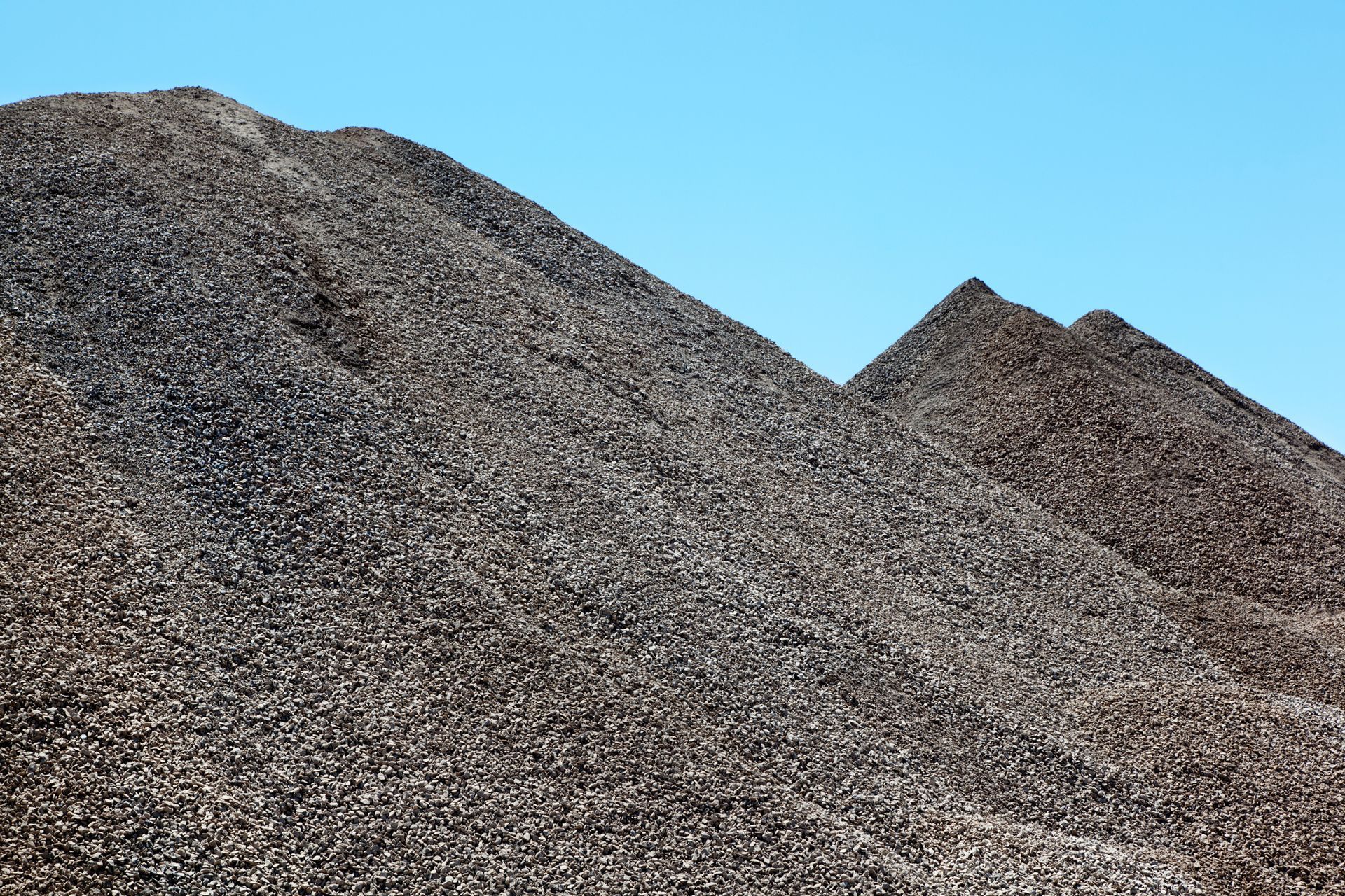 Piles of crushed stone sold by R. Pepin and Sons Inc., and used as construction aggregates in Dover, NH.