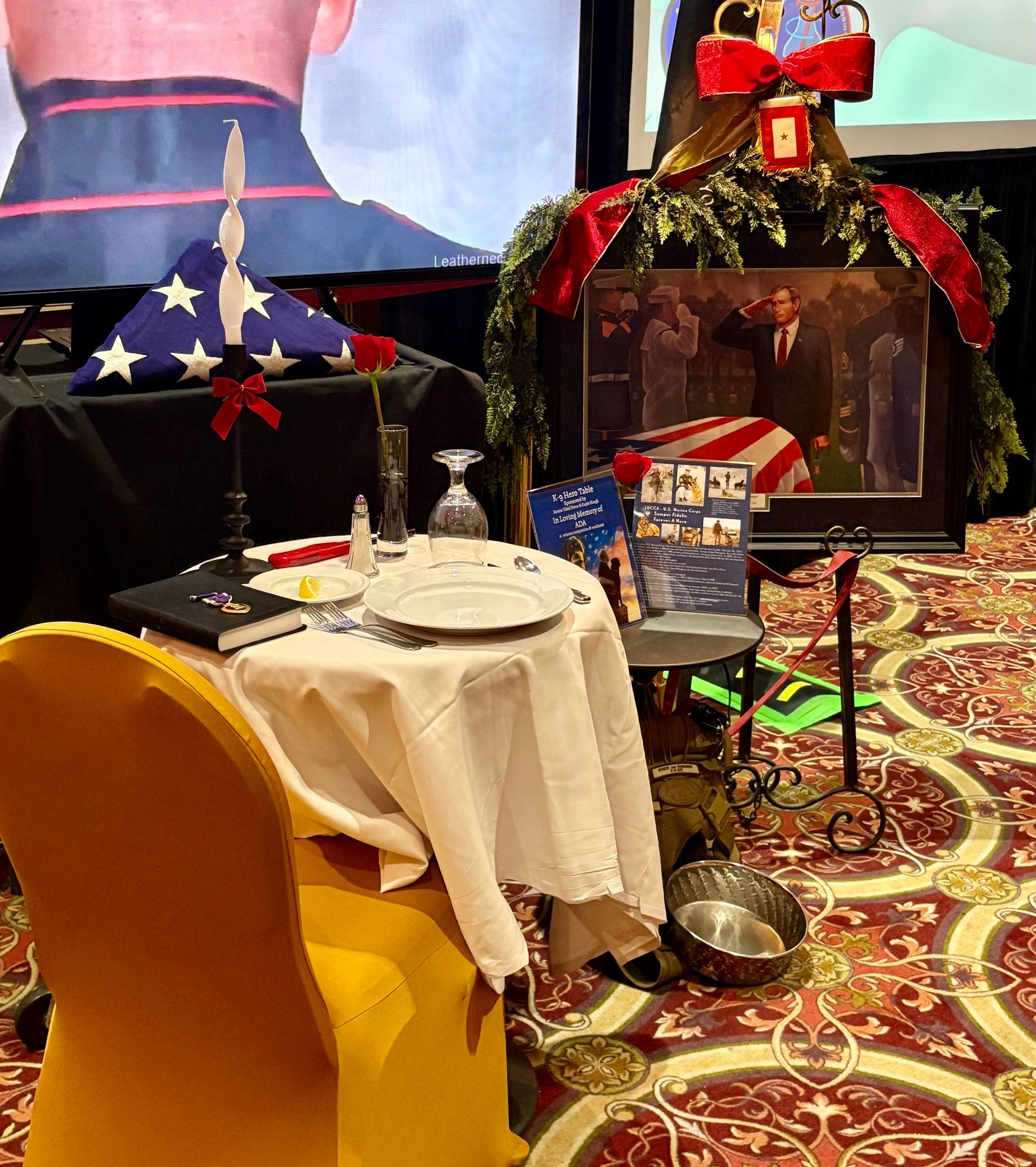 Decorated table and chair in a festive room with garlands, gifts, and patterned carpet