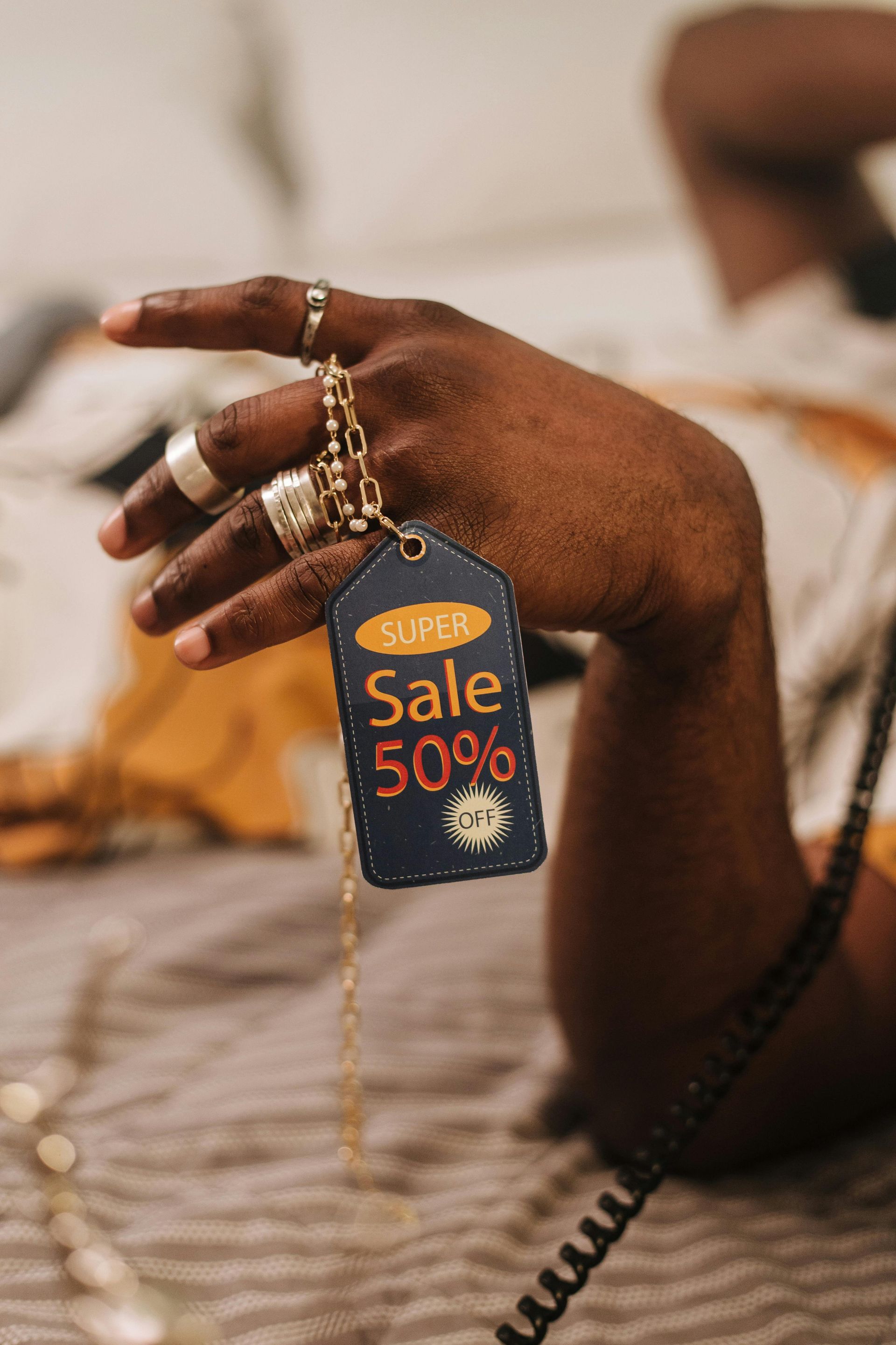 A person is holding a sale tag in their hand.
